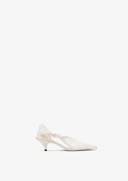 Coppelia 50 slingback by Boutashkova, a close-up of a white pointed-toe high heel with a textured fabric upper and a twisted detail at the ankle, shown on a light gray background.