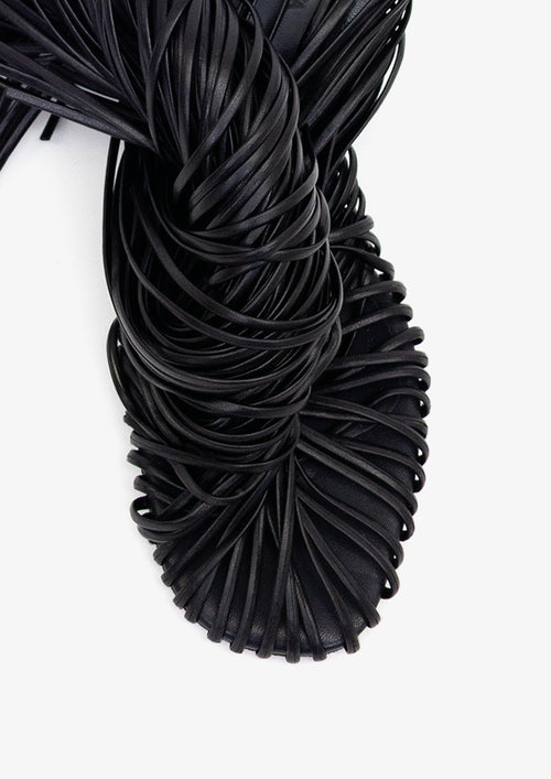 Fringe 60 sandal by Boutashkova, a single black high-heeled mule sandal with an intricate fringed strap design, shown from a side profile against a solid white background.